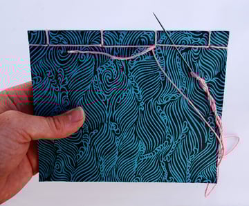 Sew around the tail moving the needle underneath the two surrounding stitches