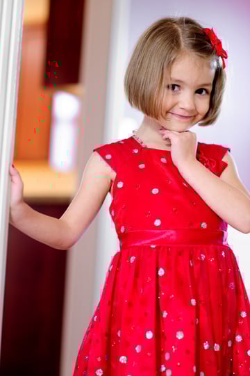 There's only natural window light in this image, but it appears soft because the girl is standing in a very reflective white room.