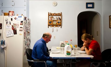 Charity Miles and her father Craig Miles pray before breakfast the morning of the Sandhills marathon. French toast for breakfast is a tradition that has been carried in their family before sporting events since Charity was in high school.