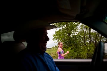 Charity Miles laughs as her dad drives past her during the Sandhills marathon on Brownlee Road Saturday. "When I was in high school my family was still pretty new to the whole running thing and they were very afraid that I would get hurt or someone would kidnap me if I went out running by myself even way out here in the Sandhills so they would drive along the highway at like 4mph for umpteen miles at a time. As embarrassing as that is to admit, but that’s kind of how I started running on the Brownlee Road," she says.