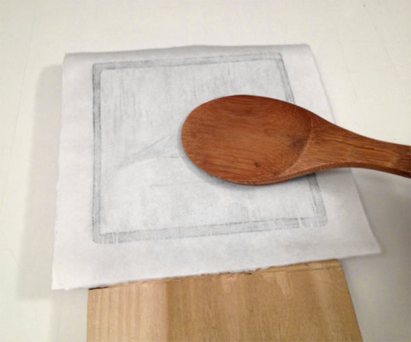 lightly rub the back of the paper with the rice spoon