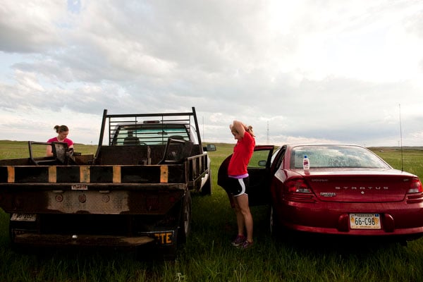 Charity Miles stretches by her car Saturday morning before everyone loads onto the bus that will take them to the half marathon's starting line. This is her second year running the race and usually runs on the road as a normal route, but says it's hard for people not from Valentine to realize how close it is to people's homes. "You can always tell the people that are not from the area and are going up to Merritt Dam because they drive very, very fast and they look at you like you’re crazy for running out in the middle of nowhere and you can tell that they’re wondering how far you’ve been running because they thought the last town was 45 minutes away."