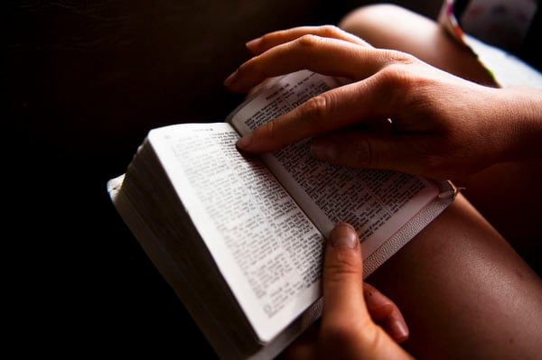 Charity Miles reads scripture from her bible on the bus ride to the starting line of the Sandhills half-marathon Saturday morning.