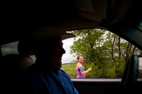 Charity Miles laughs as her dad drives past her during the Sandhills marathon on Brownlee Road Saturday. "When I was in high school my family was still pretty new to the whole running thing and they were very afraid that I would get hurt or someone would kidnap me if I went out running by myself even way out here in the Sandhills so they would drive along the highway at like 4mph for umpteen miles at a time. As embarrassing as that is to admit, but that’s kind of how I started running on the Brownlee Road," she says.