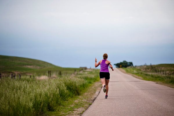 Charity Miles gives a thumbs-up as she passes her dad on Brownlee road during the Sandhills half-marathon. "When I was in high school my family was still pretty new to the whole running thing and they were very afraid that I would get hurt or someone would kidnap me if I went out running by myself even way out here in the Sandhills so they would drive along the highway at like 4mph for umpteen miles at a time. As embarrassing as that is to admit, but that’s kind of how I started running on Brownlee Road."